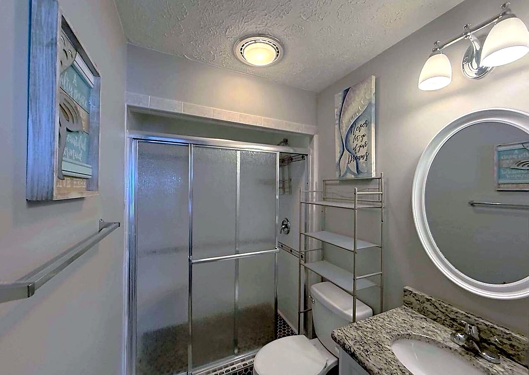 Primary bathroom with a tiled walk-in shower
